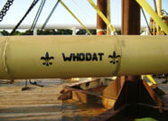 A pipe with the Who Dat logo spray painted on it